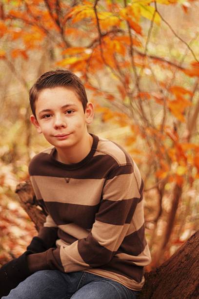 istock Teenager Sitting on Log 591438698