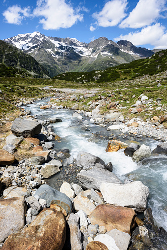 An alpine stream located in the mountain range Stubai Alps close to the mountain Wilder Freiger (European Alps, Tyrol, Austria). In the background is the mountain Ruderhofspitze (3.474 m) visible.