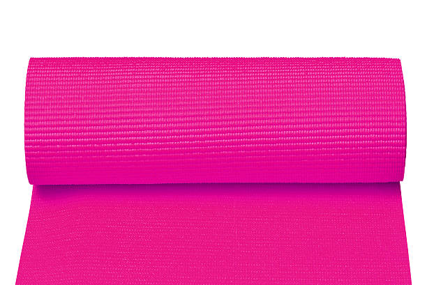 istock Pink yoga mat isolated on white 591439778