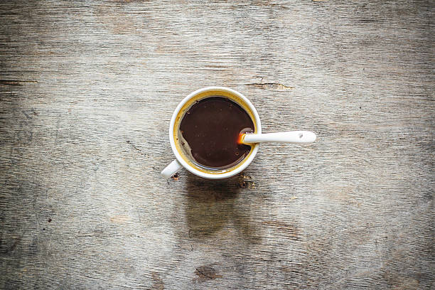 istock Coffee cup top view on wooden table background 591441632