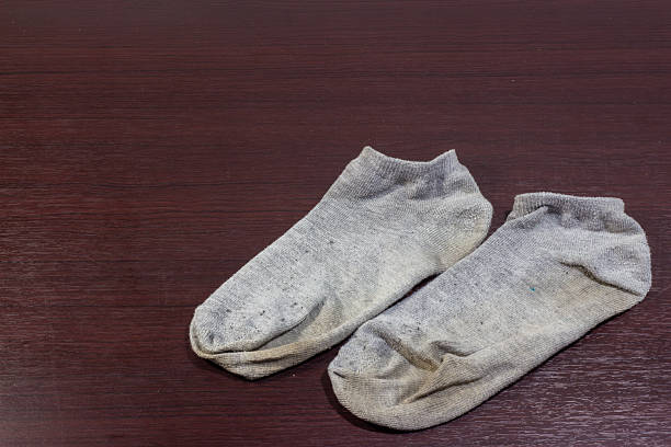 istock Used dirty socks on wooden floor 591442086