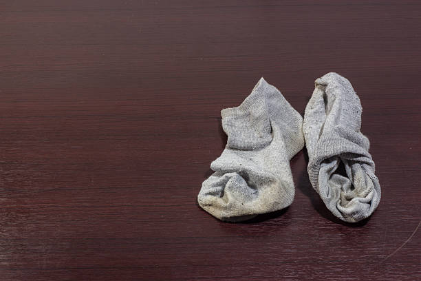 Used Dirty Socks On Wooden Floor Stock Photo - Download Image Now