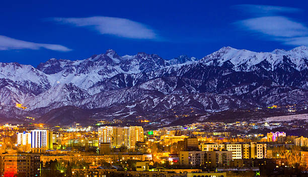 almaty y las montañas bajo la luz de la luna - almaty fotografías e imágenes de stock