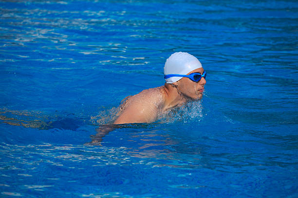istock Young man swimming in a pool    Male swimmer 591444586