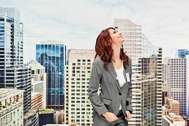 istock Smiling businesswoman outdoors and looking up 591448232