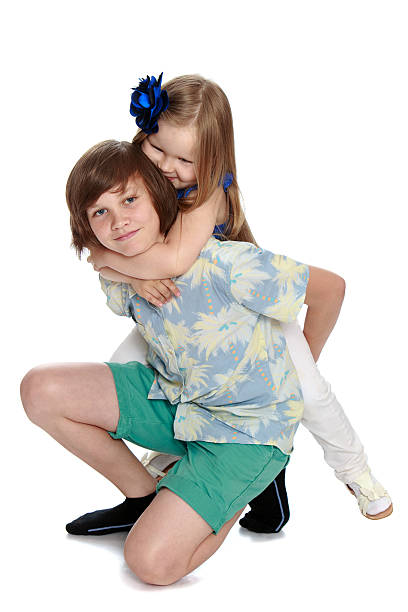istock Brother and sister hugging 591448278