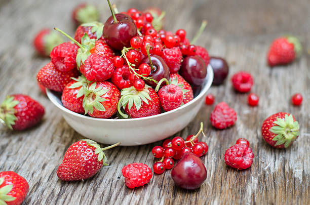 istock Ripe fruit and berries on a wooden table 591448528