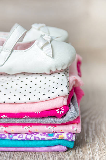 istock Folded pink and white bodysuit with shoes 591781652