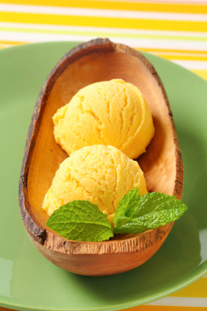 istock Yellow ice-cream in wood bowl 591788532