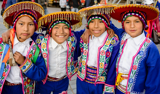 Lima, Peru - June 17, 2016: Young boys dressed in traditional colorful  folkloric costumes.  They are waiting to perform traditional dances in parade during a religious festival.