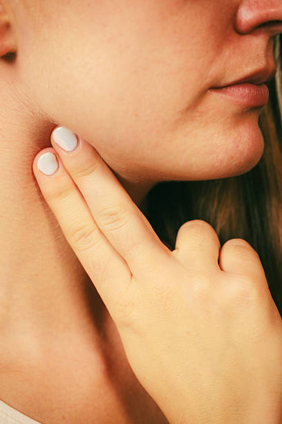 istock Woman checking pulse on neck closeup 591790376