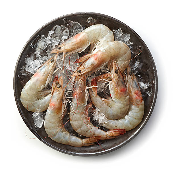 fresh raw prawns on black plate