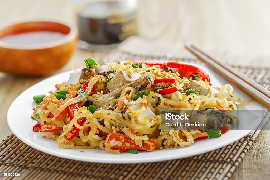 Pad Thai Oriental food made of rice noodles, tofu, vegetables and shiitake mushrooms. Delicious Oriental cuisine meal. Close-up. Pasta Stock Photo