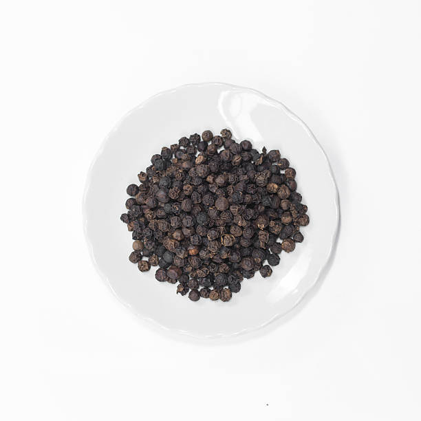 istock Black pepper in disc isolated on white background 591807284