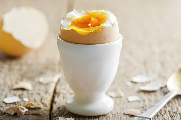 Perfect soft boiled egg for breakfast Perfect soft boiled egg on a table. Traditional food for healthy breakfast. Close-up shot. boiled egg photos stock pictures, royalty-free photos & images