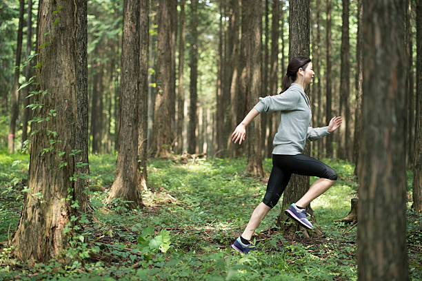 Young woman running in the woods.