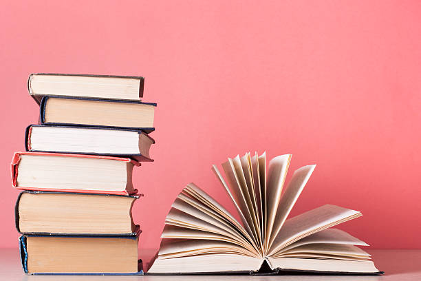 istock Open book, hardback books on wooden table. Education background. Back 591810594