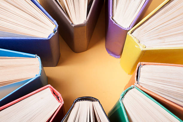 istock Open book, hardback books on wooden table. Education background. Back 591810990