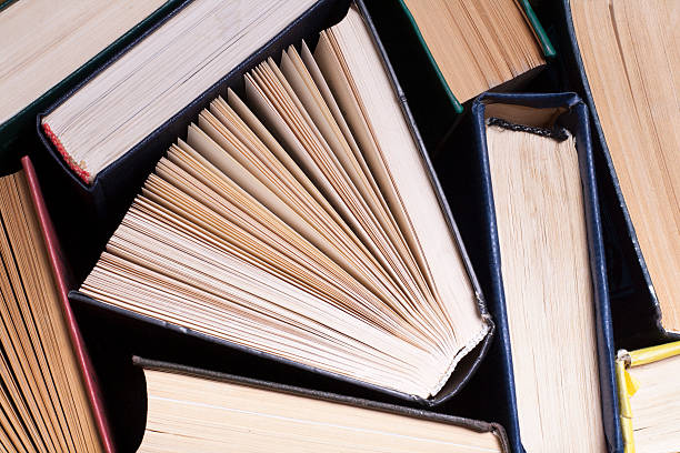 istock Open book, hardback books on wooden table. Education background. Back 591811454