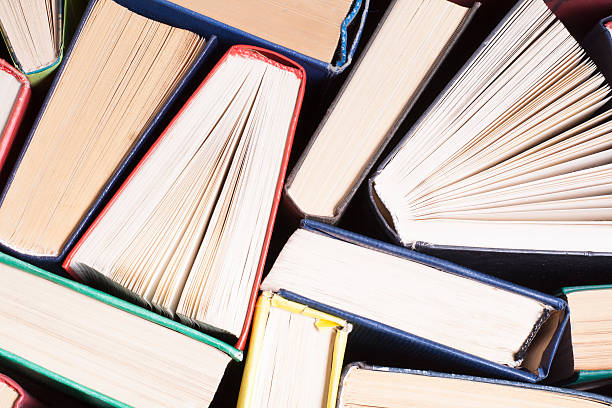 istock Open book, hardback books on wooden table. Education background. Back 591811474