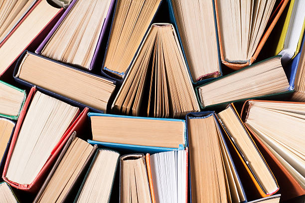istock Open book, hardback books on wooden table. Education background. Back 591811500