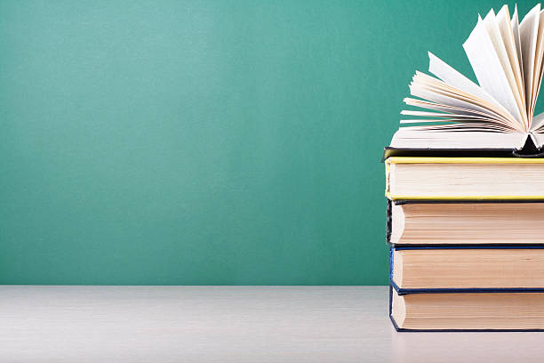 istock Open book, hardback books on wooden table. Education background. Back 591811718