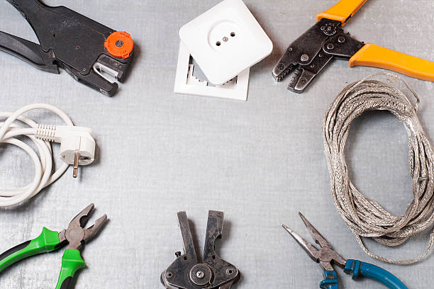 istock Set of electrical tool on wooden background. Accessories for engineering 591811944