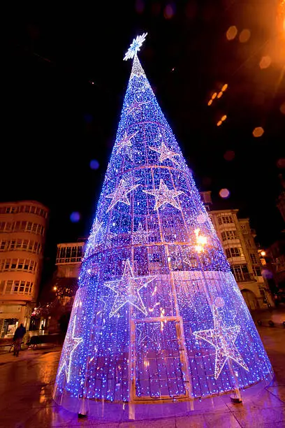 Modern lighting Christmas tree in a townsquare in Lugo, Galicia, Spain in a rainy night.