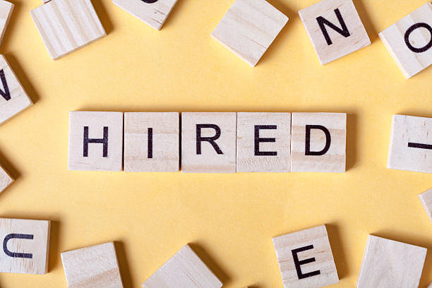 istock text of HIRED on cubes. Wooden abc 591813876