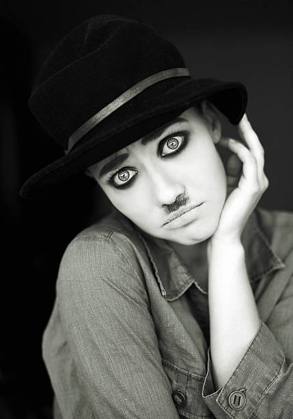 playing her character monochrome shot of funny actress with Charlie Chaplin makeup looking at camera with sad puppy eyes.wearing hat. actress headshot stock pictures, royalty-free photos & images