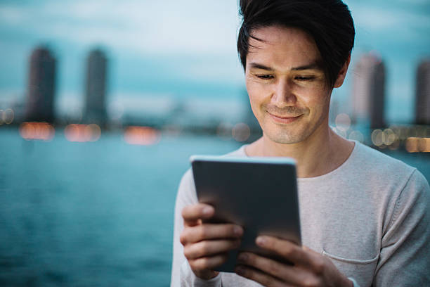istock Man with digital tablet and cityscape 591816262