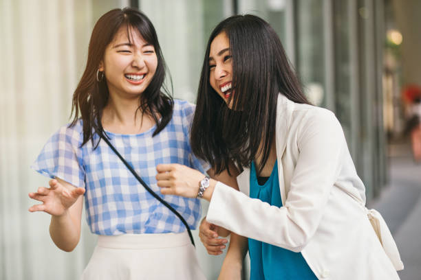istock Girlfriends laughing on the street 591816548