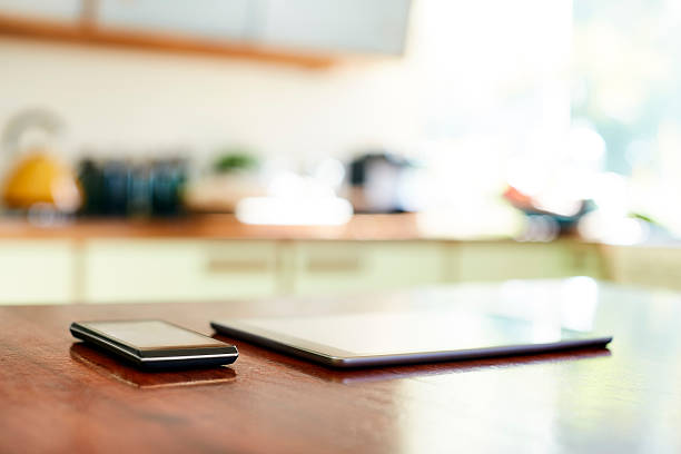 istock Close-up of smart phone and digital table on table 591816628