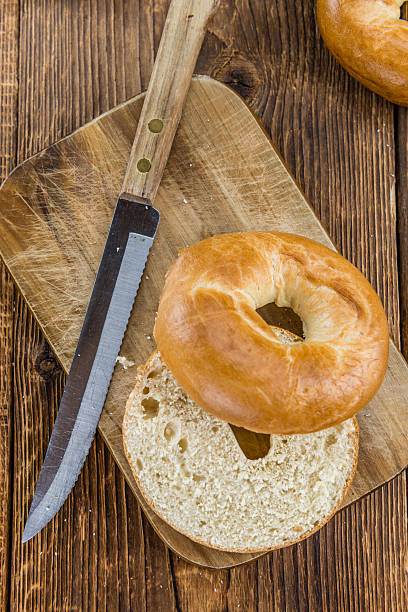 istock Fresh baked Bagels on a wooden table 591817118