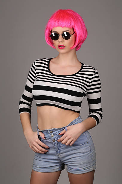 girl with circle sunglasses and pink hair. close up. gray - shirt fine art portrait vertical head and shoulders imagens e fotografias de stock