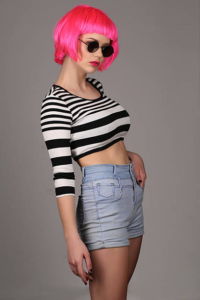 model with circle sunglasses and pink wig. close up. gray - shirt fine art portrait vertical head and shoulders imagens e fotografias de stock