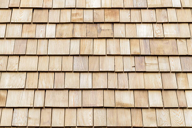 istock Several wood cedar shingles for siding or roofs. 591817696