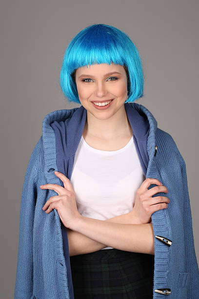 smiling lady in blue wig and coat posing with crossed - shirt fine art portrait vertical head and shoulders imagens e fotografias de stock