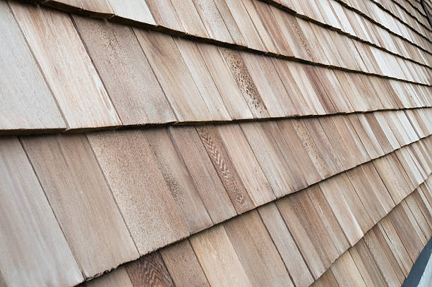 istock Several wood cedar shingles for siding or roofs. 591818312