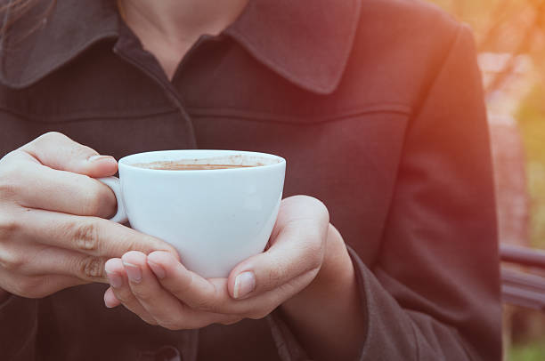 istock Woman holds coffee cup 591818802
