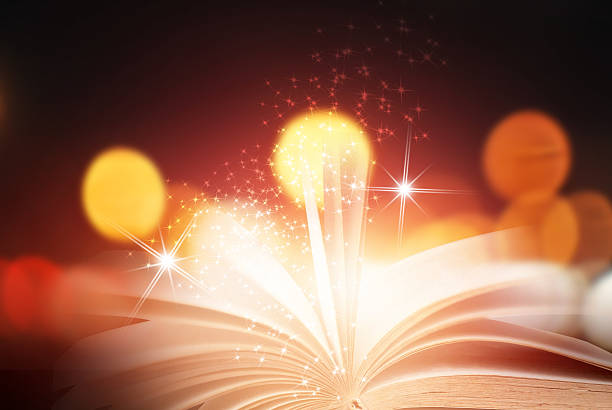 istock Abstract magic book on wooden background 591819112