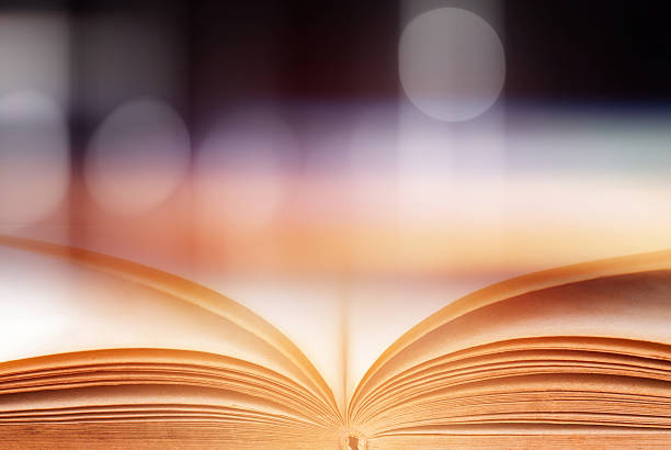 istock Abstract magic book on wooden background 591819176