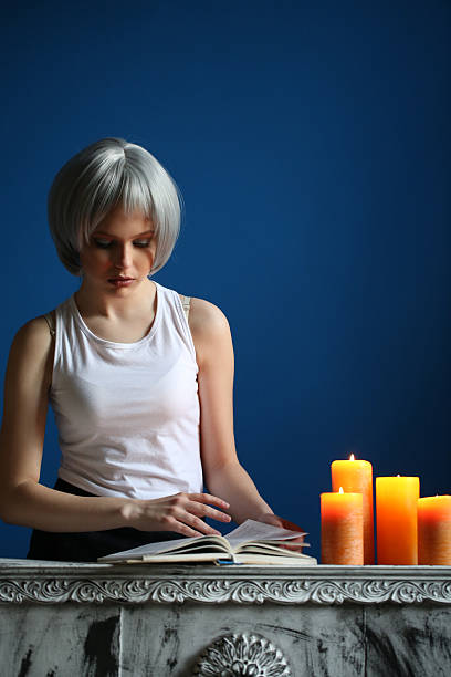 teen model posing and leafing through the book. close up - shirt fine art portrait vertical head and shoulders imagens e fotografias de stock