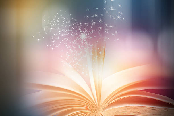 istock Abstract magic book on wooden background 591819374
