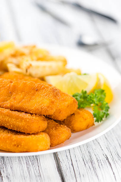istock Portion of Fish Fingers (selective focus) 591822568