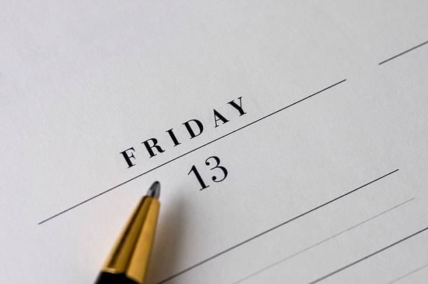 Friday the 13th Friday the 13th on a desk calendar with a pen. friday the 13th stock pictures, royalty-free photos & images