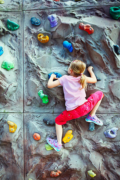 istock Young girl climbing on the wall 591823190