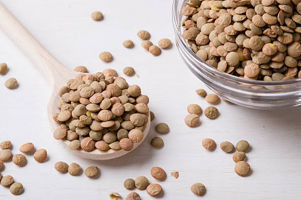 istock lentils with wooden spoon 591823808