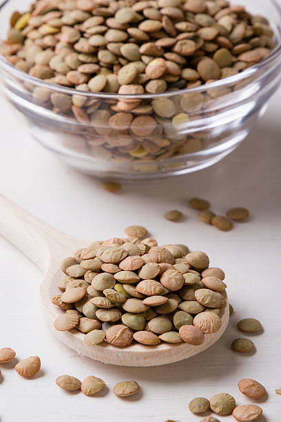 istock lentils with wooden spoon 591823844