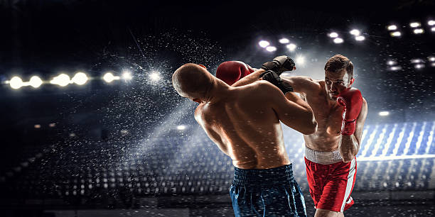 Box professional match . Mixed media Two professional boxers are fighting on arena panorama view boxing stock pictures, royalty-free photos & images